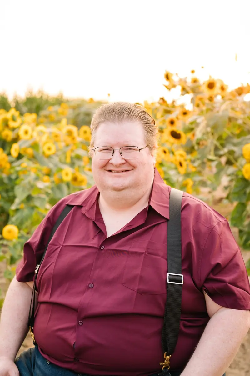 Aaron Fine in a sunflower field